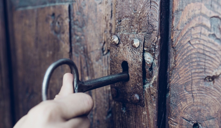 Key opening a door.