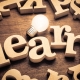 The word learn spelled out with wooden letters.