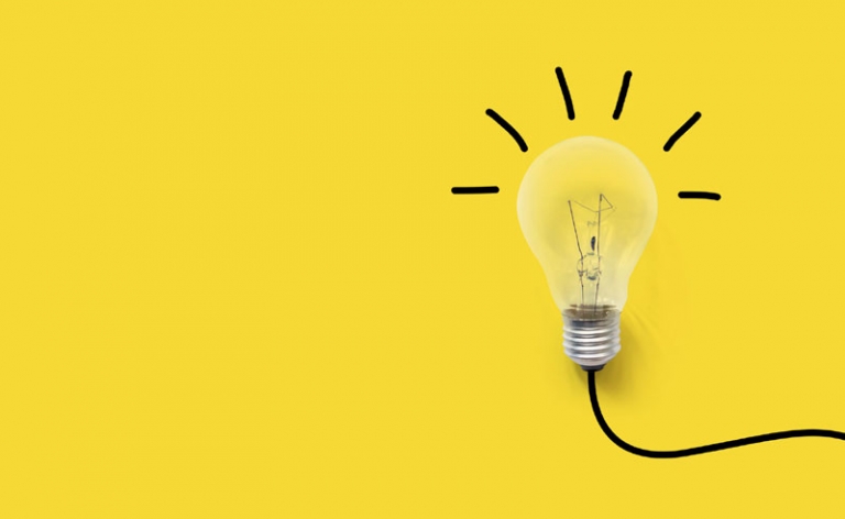 Yellow background with image of a light bulb turned on.