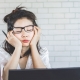 Woman in front of computer looking tired and not getting work done.